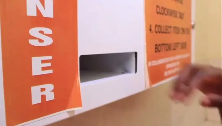 A university pilot documentary shows how the token-operated dispenser works alongside partner interviews.