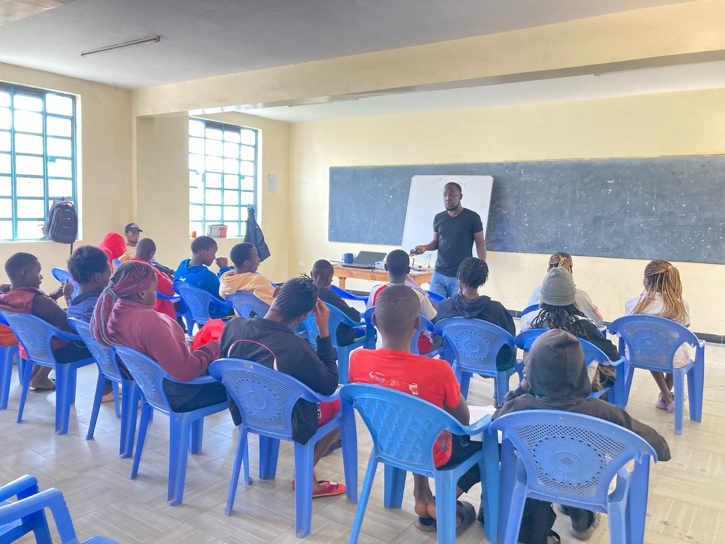 A Wazi AYP mentorship session in progress, mentees and facilitators in a workshop setting.