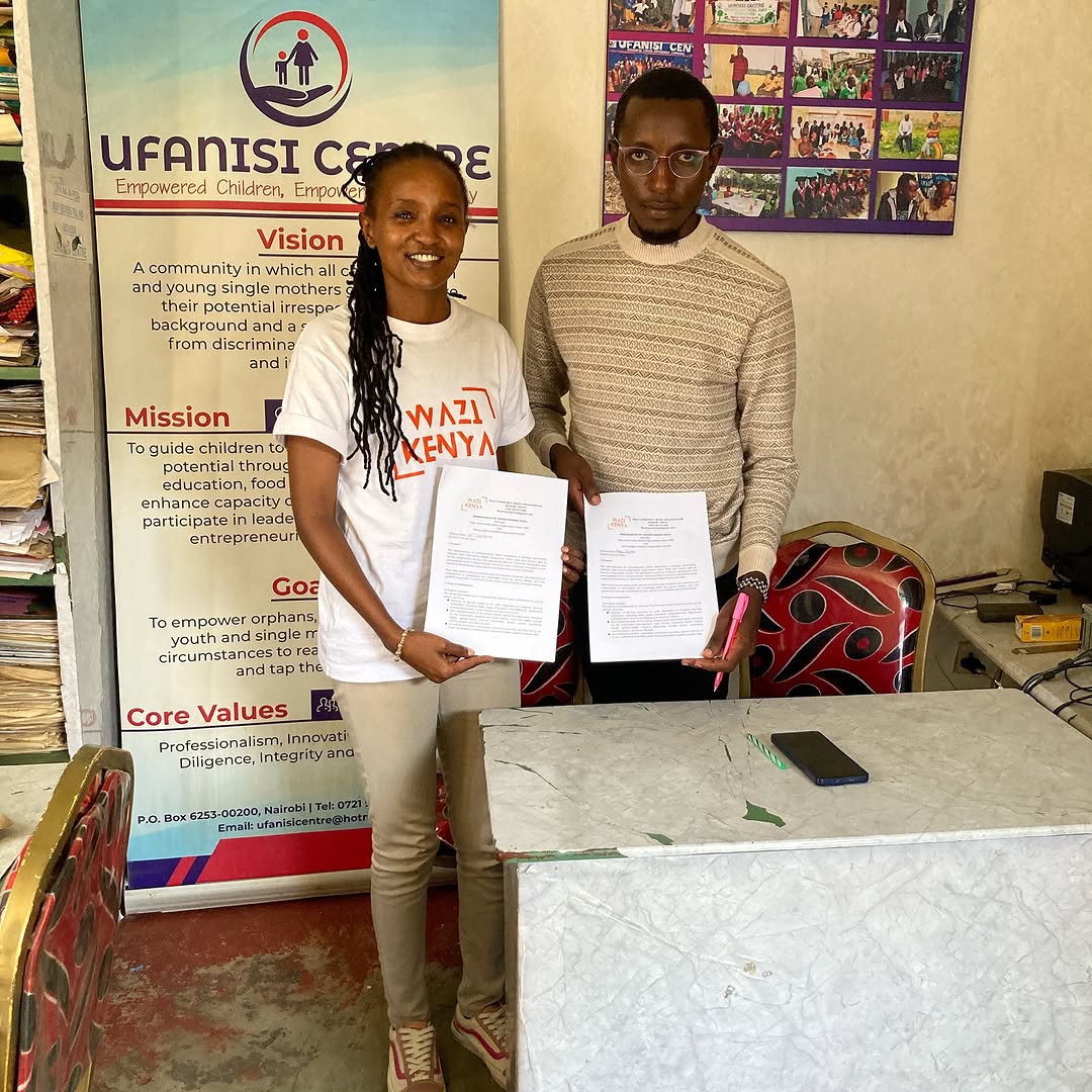 Wazi signing a memorandum of understanding with a partner organization.